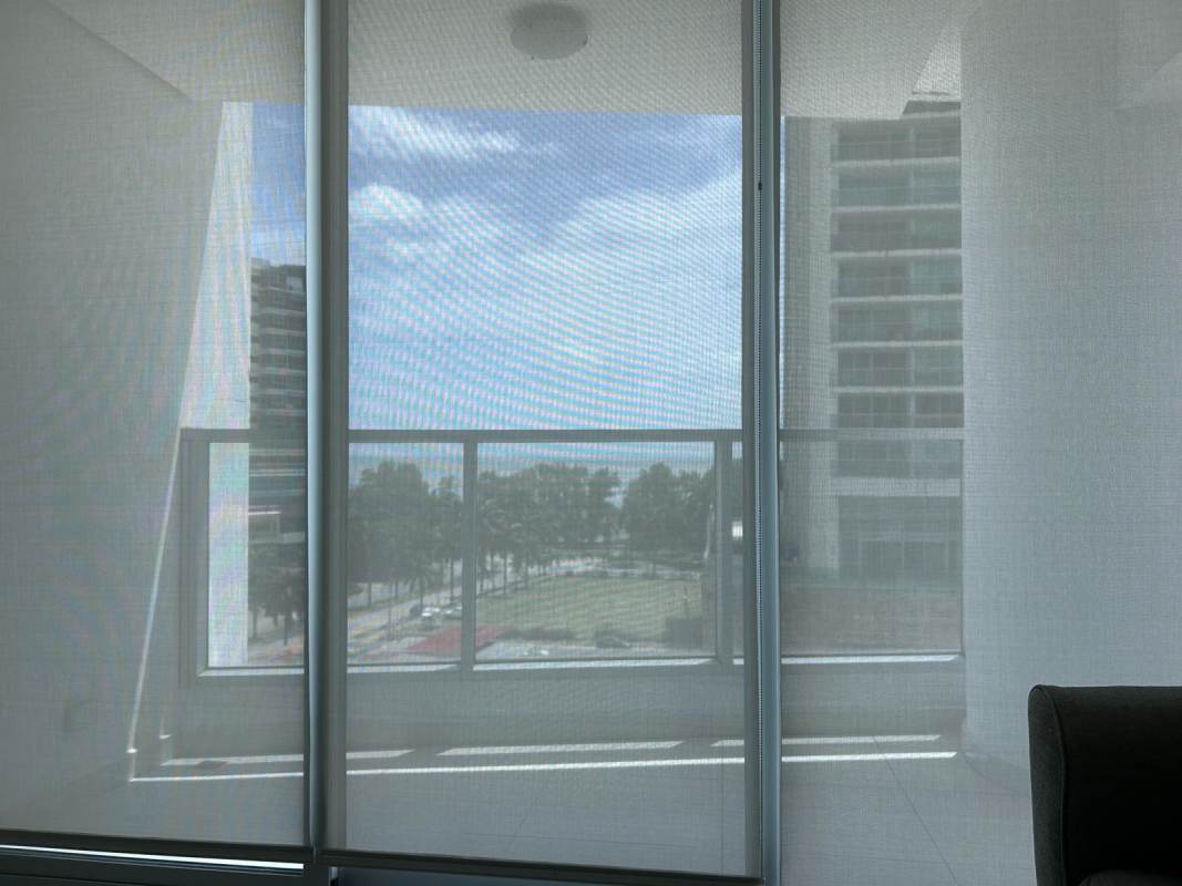 Floor-to-ceiling glass doors to balcony with city and partial ocean views PH Parkside