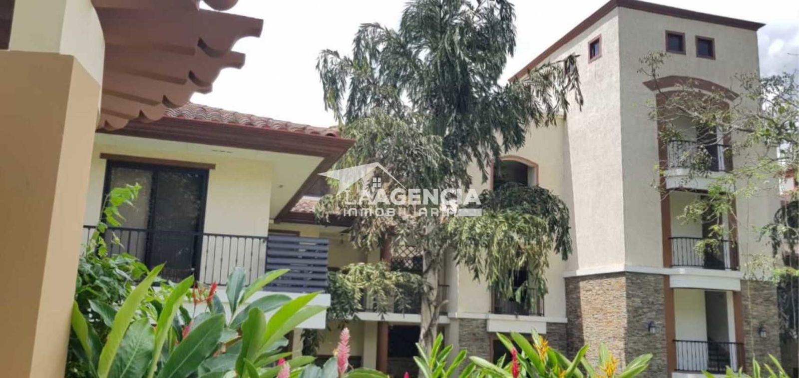 Sunny Mediterranean architecture with red tile roofs lush gardens and balconies Embassy Club Clayton Panama