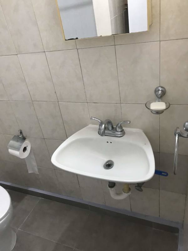 Small tiled bathroom with wall sink and mirror cabinet Don Bosco Panama