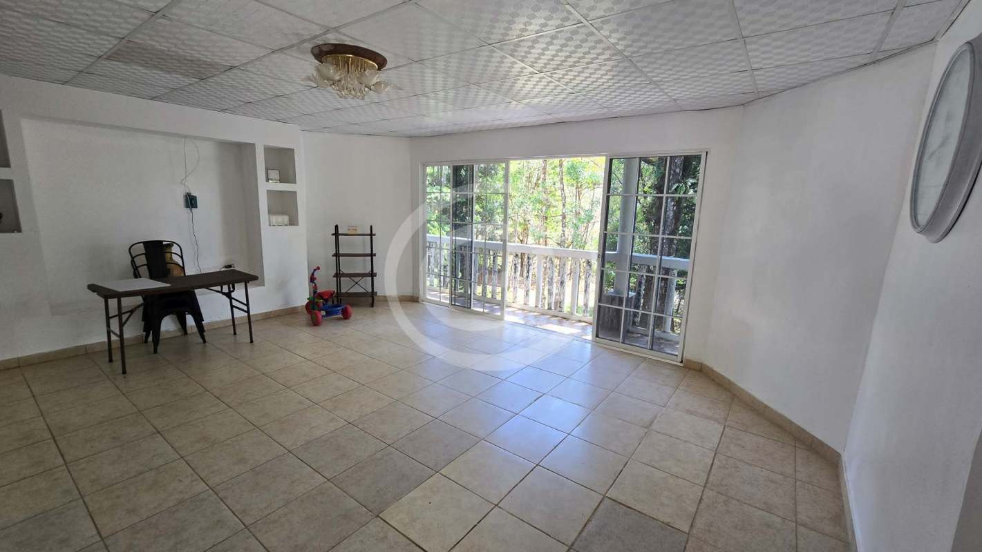 Spacious living room with large windows and exit to terrace in Altos de Cerro Azul home