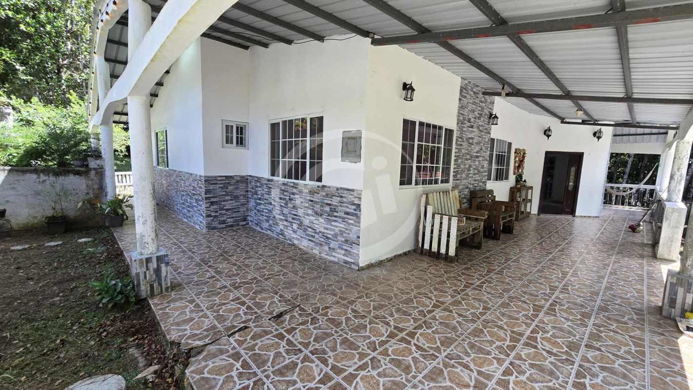 Rustic facade with stone accents, covered porches, mountain house in El Guardián Cerro Azul