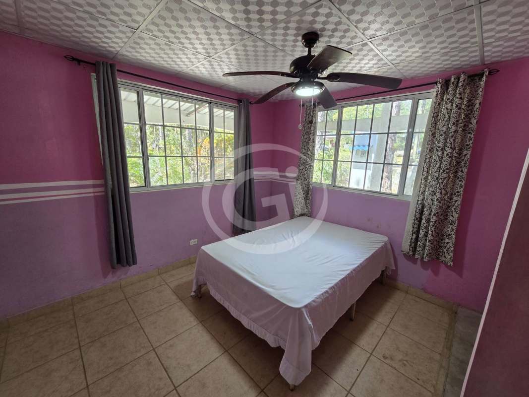 Bright kitchen with breakfast bar, windows overlooking greenery in Altos de Cerro Azul