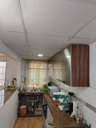 Kitchen with granite countertop and wooden cabinets in furnished house La Chorrera Panama
