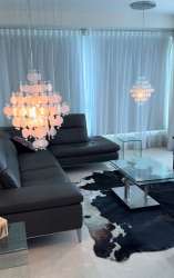 Modern living room with large sectional and ocean view windows at PH Playa Bonita Veracruz Panama