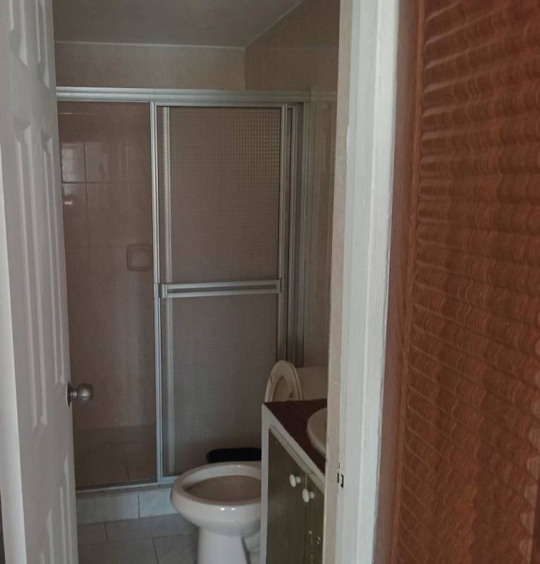 Small bathroom with glass shower door, vanity and toilet, Bella Vista Park Panama