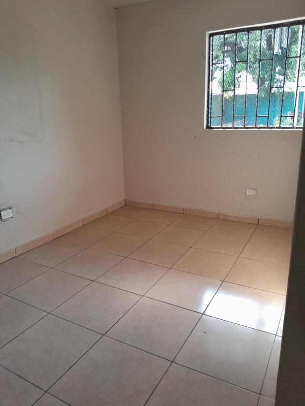 Empty bedroom with tile floor and barred window affordable room in Pacora Panama