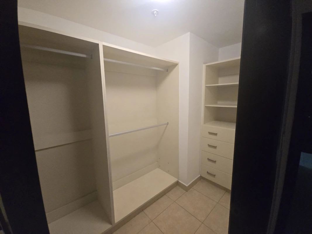 Large walk-in closet with built-in shelves in furnished unit PH Parque del Mar Costa del Este Panama City for rent