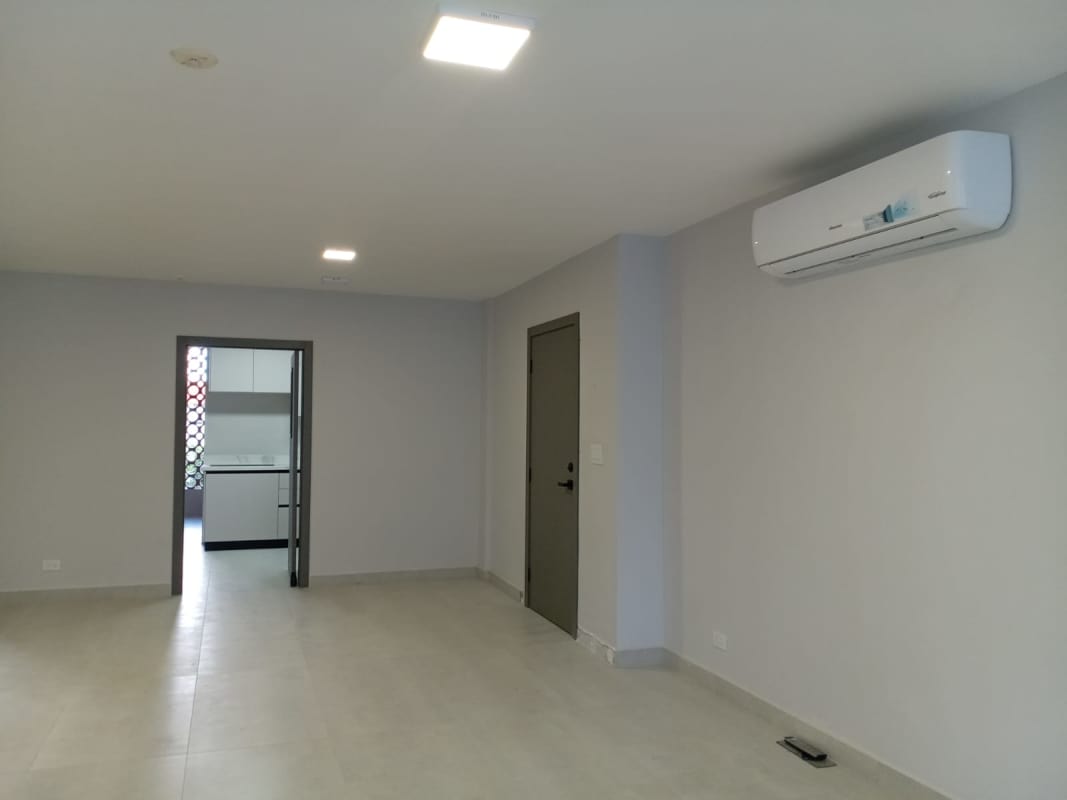 Bright living room with large sliding glass doors to balcony overlooking greenery in PH San Francisco Exclusive Panama City