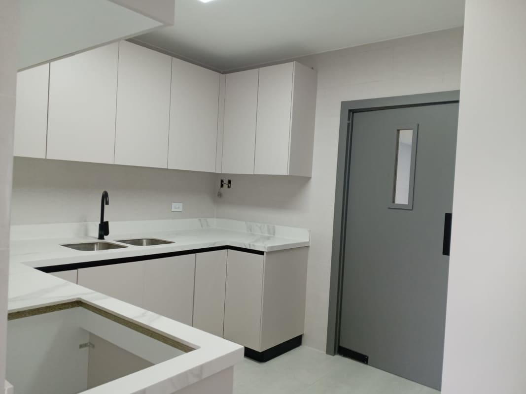 Minimalist modern kitchen with marble-style counters and white cabinets in PH San Francisco Exclusive