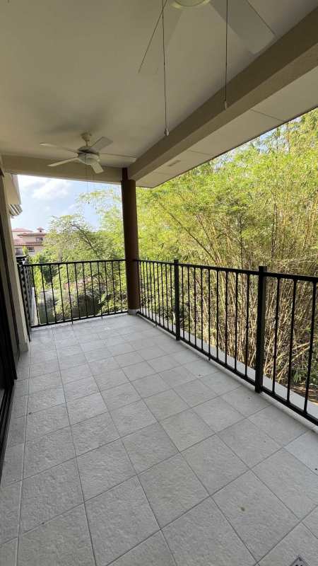Covered balcony with ceiling fans and lush green view Embassy Club Clayton Panama