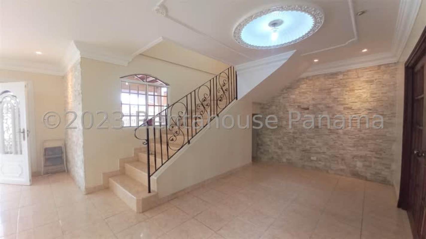 Spacious kitchen with granite island, dark wood cabinetry, oven and gas cooktop Residencial San Antonio Panama