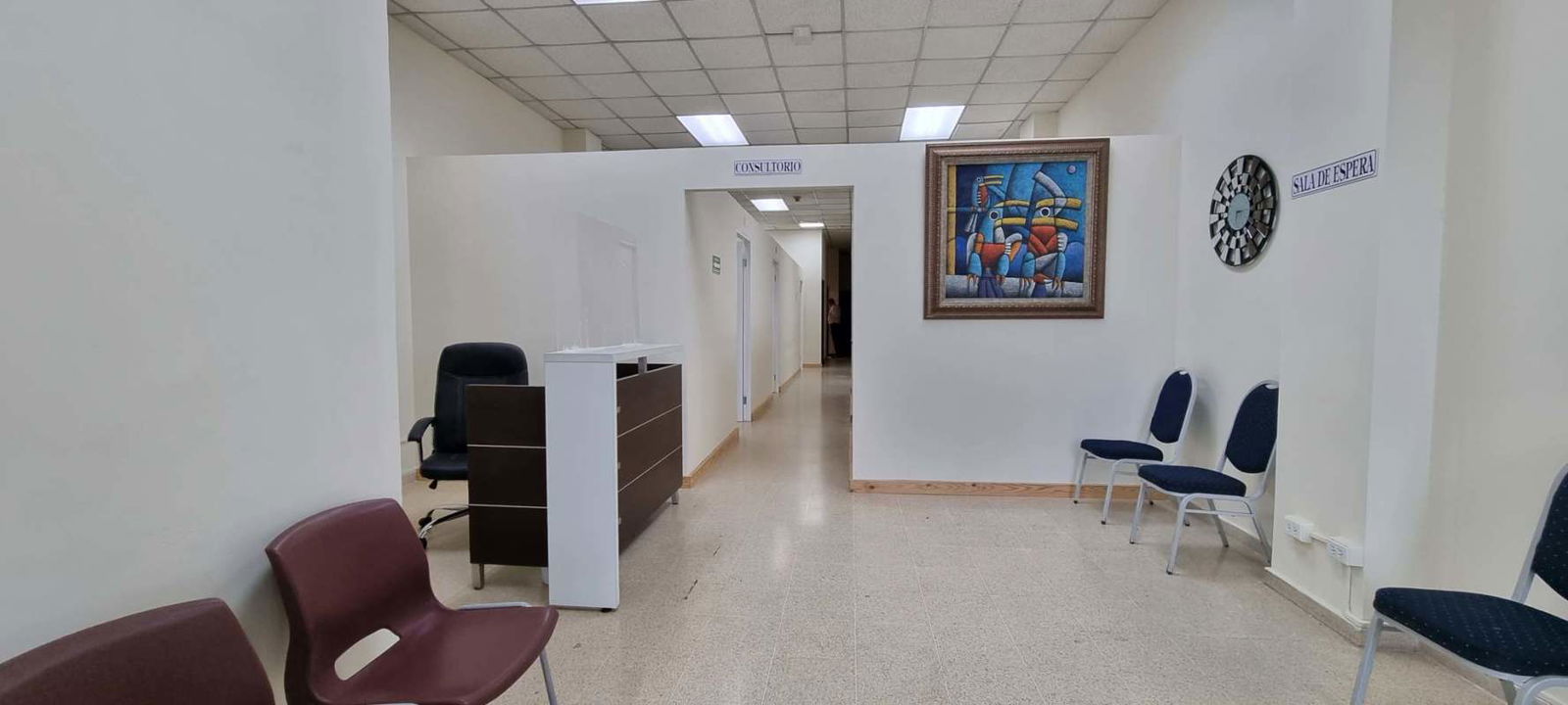 Industrial storage room with metal shelving, bins, fridge in commercial plaza office Panama City