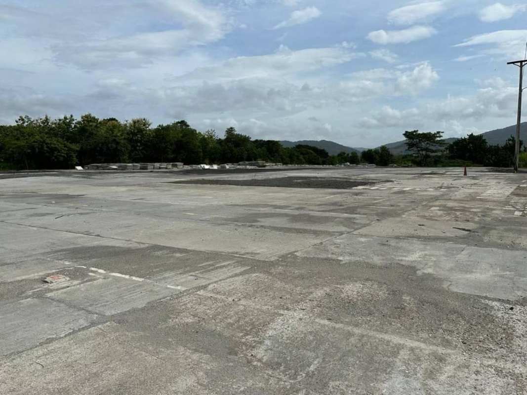 Chain-link fenced industrial lot next to main road at Brisas del Golf Panama