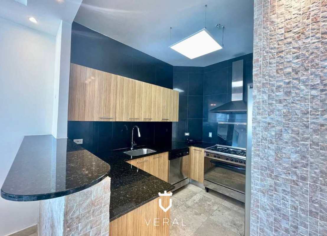 Bedroom with large windows, glass door access to balcony with panoramic water views PH SKY Residences Panama City