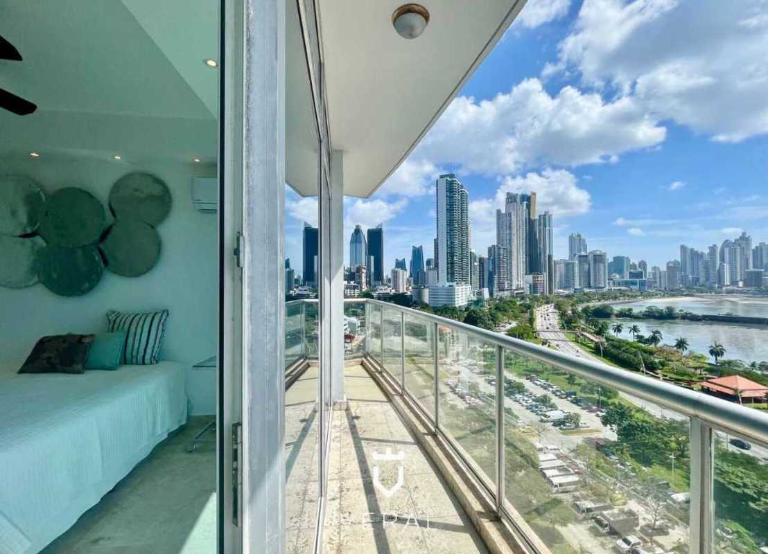 Open American kitchen with granite counter and stainless steel appliances at PH SKY Residences Panama City