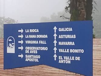 Directional wooden sign to La Rioca, Virginia Fall, Valle Bonito near misty forest Altos del María Panama