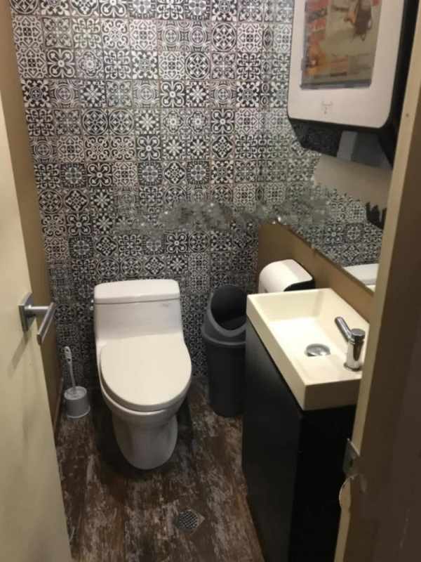 Cafe seating with stage and glass storefront inside Panama commercial property