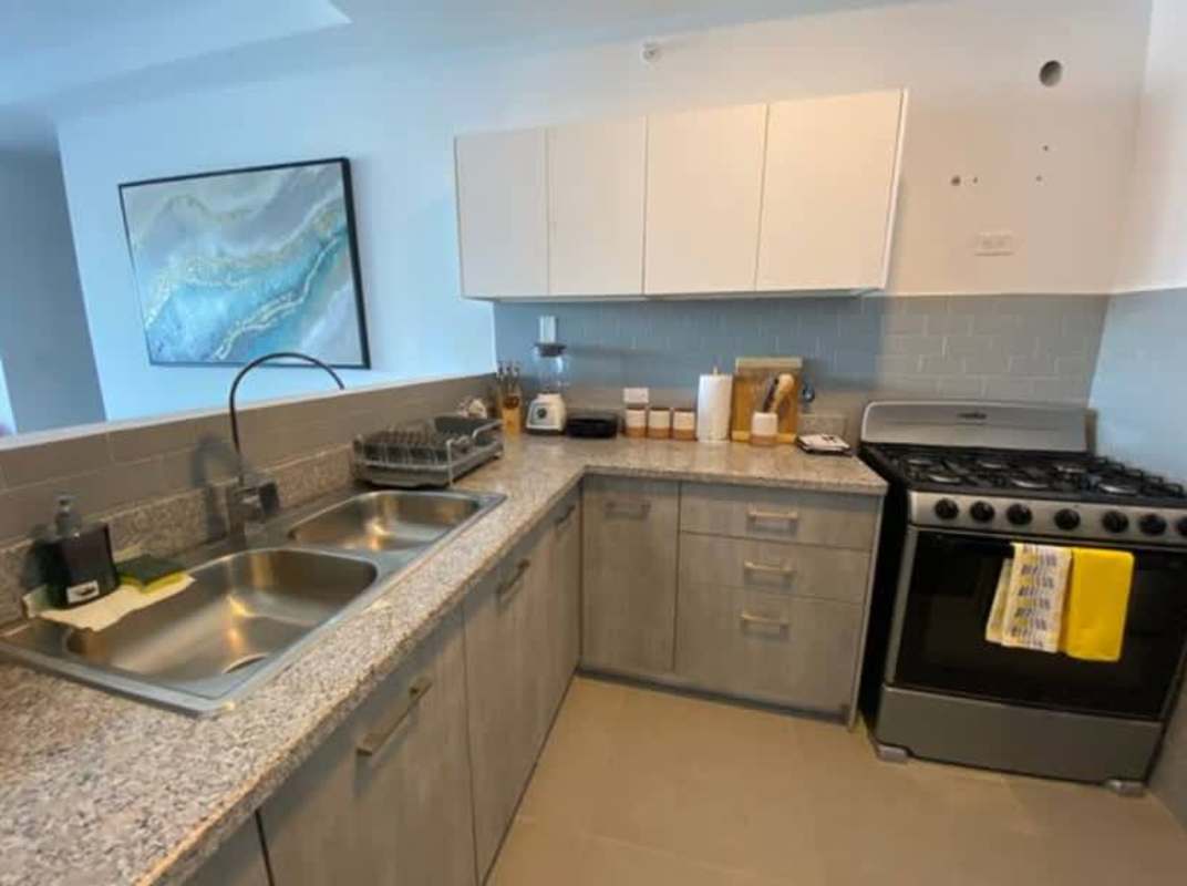 Bedroom with large window, split AC, city view, modern decor in Signature Point La Cresta Panama