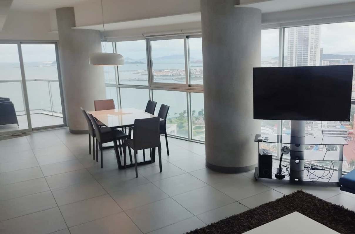 Spacious living dining space with large windows offering ocean view in PH BICSA Panama City