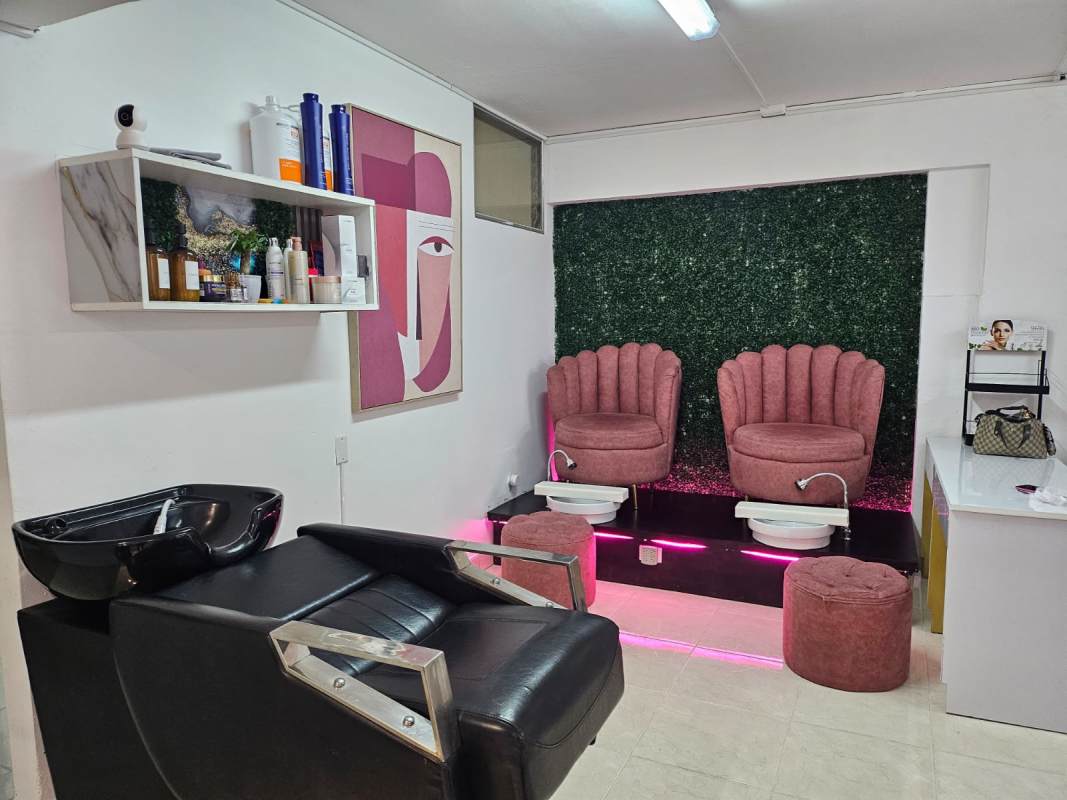 Relaxing spa treatment room with massage tables, illuminated mirrors, potted plants, and ambient decor Via España Panama