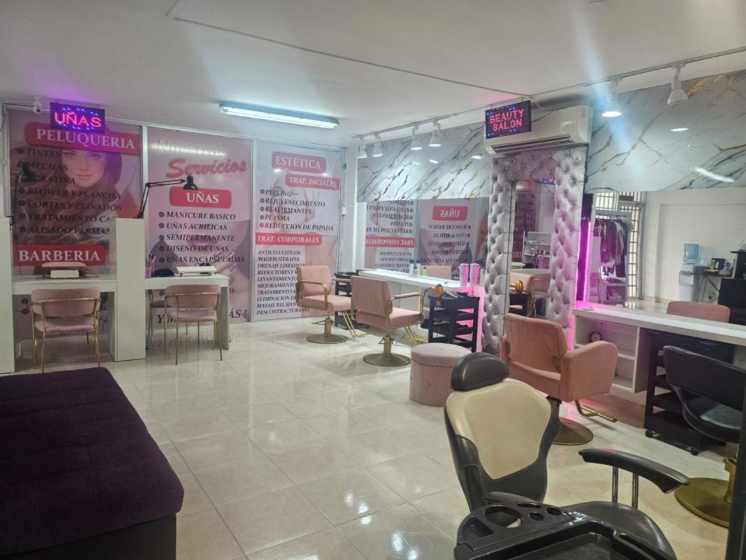 Elegant beauty salon interior, styling chairs, illuminated mirrors and signage in Panama City Via España