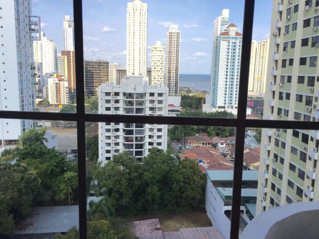 High floor window view from PH Torre Mar del Sur with city skyline and Pacific Ocean backdrop Panama City