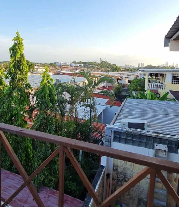 Covered outdoor patio with rustic stone walls and seating in Brisas del Golf house for rent Panama