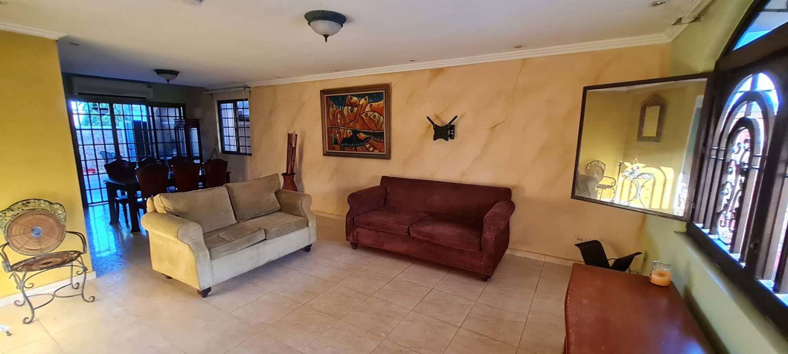 Open airy living dining space with tiled floors traditional decor Brisas del Golf rental house Panama