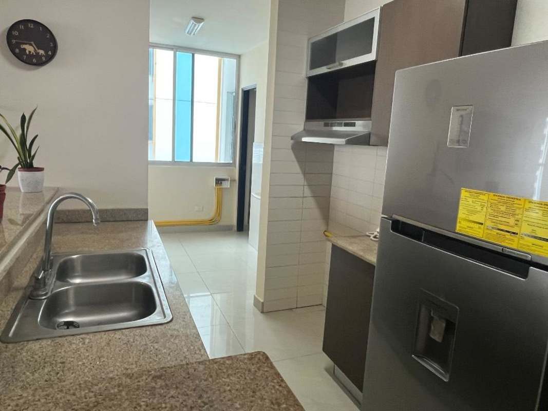 Apartment kitchen with granite countertops, window with natural light, and stainless steel appliances