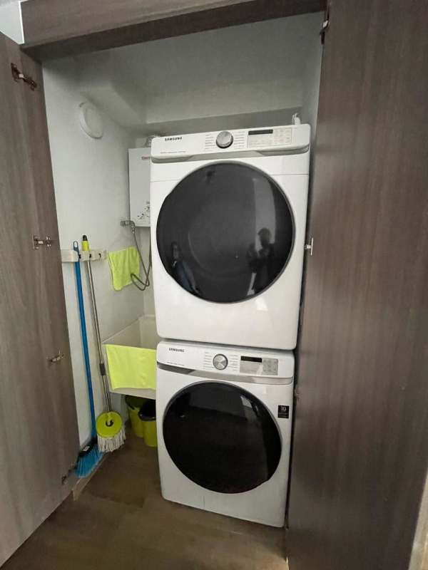 Laundry area stacked washer dryer utility sink storage PH Lumiere Costa del Este Panama