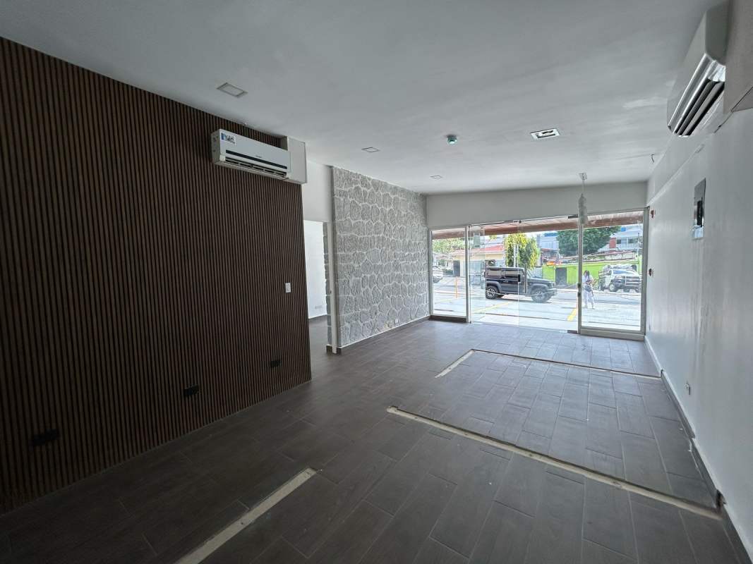 Open retail or office space with large glass storefront, accent walls and AC units in PH San Francisco Business Plaza