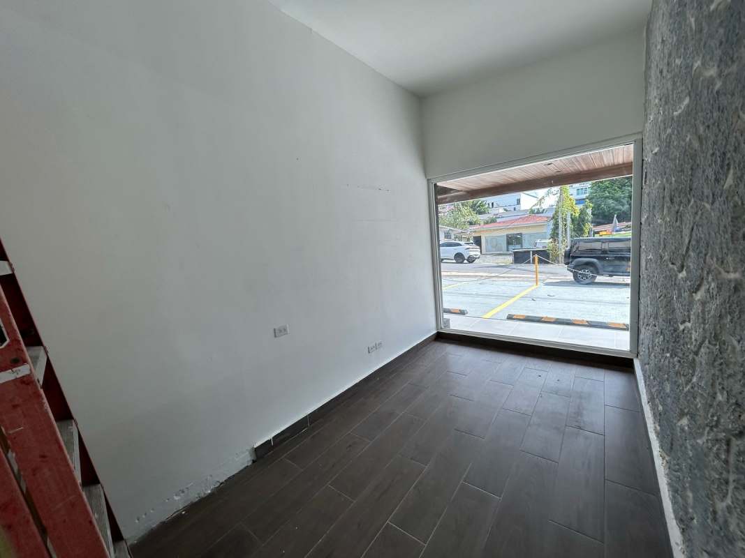 Spacious commercial interior with large windows and accent wall in San Francisco Panama