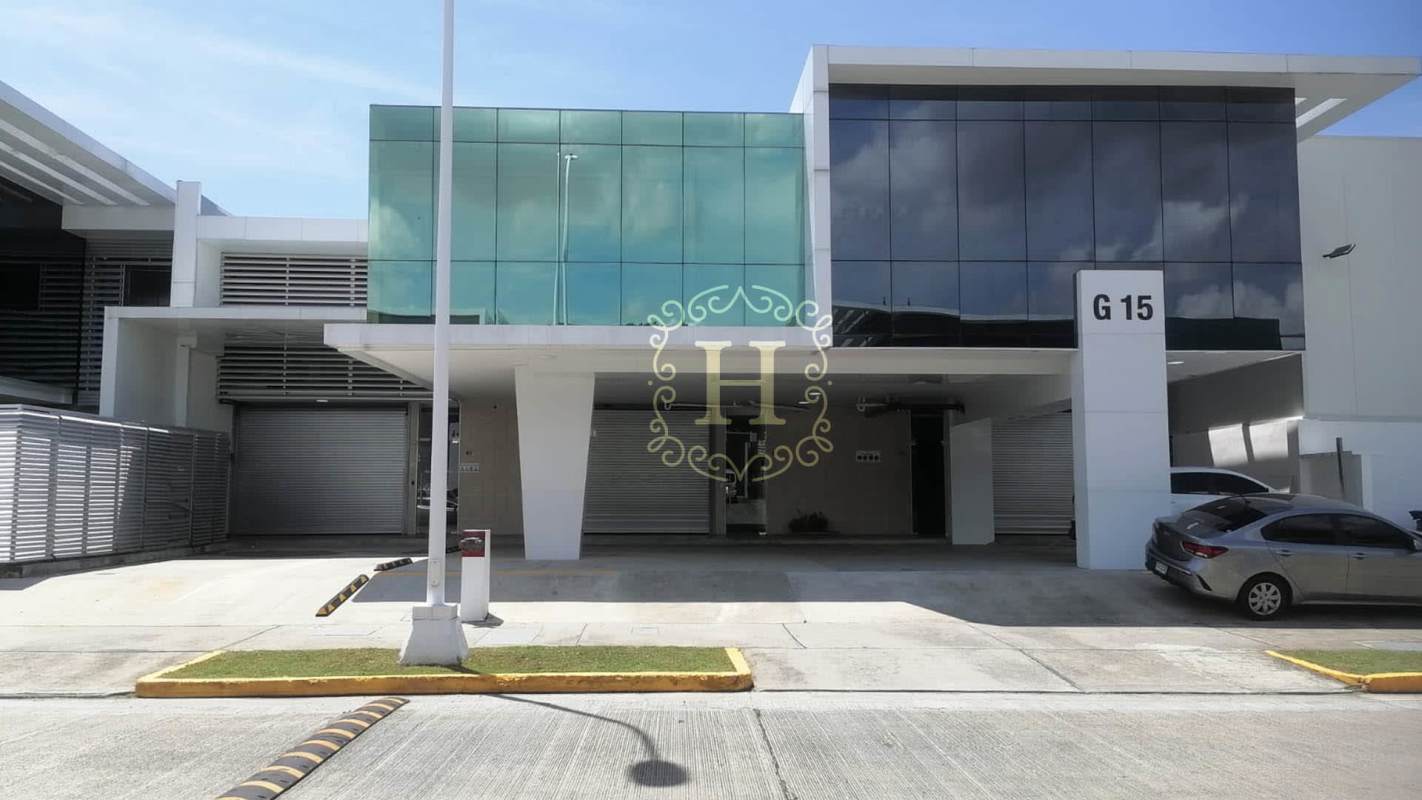 Modern commercial warehouse with large glass facade and garage door in Panama Viejo