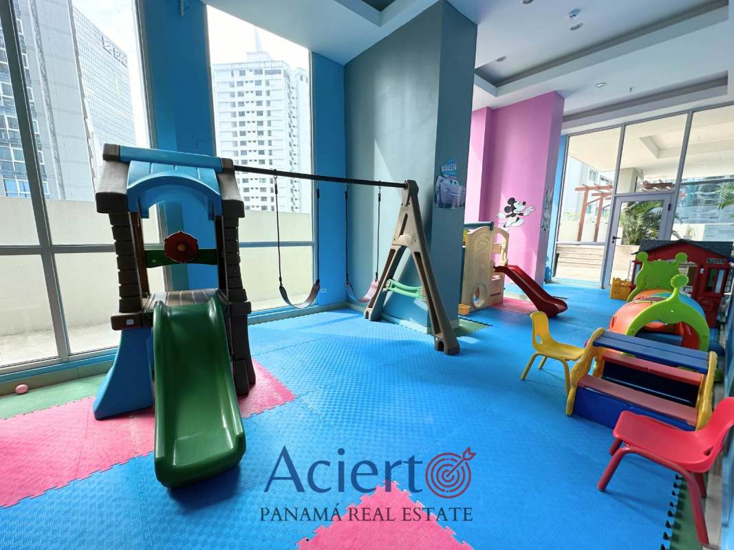 Colorful indoor children's playground with padded floor and large windows in PH Bayfront Panama