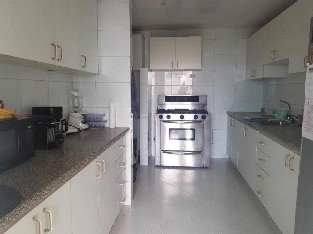 Modern kitchen with granite countertops, stainless appliances at PH Paitilla Panama City