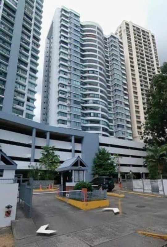 Contemporary high-rise condominium tower with balconies and gated entrance in Punta Paitilla Panama