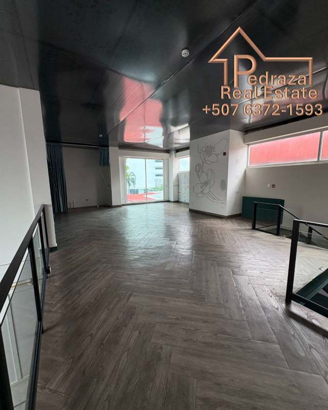 Large open interior with floor-to-ceiling glass doors and decorative wall mural Coco del Mar Panama