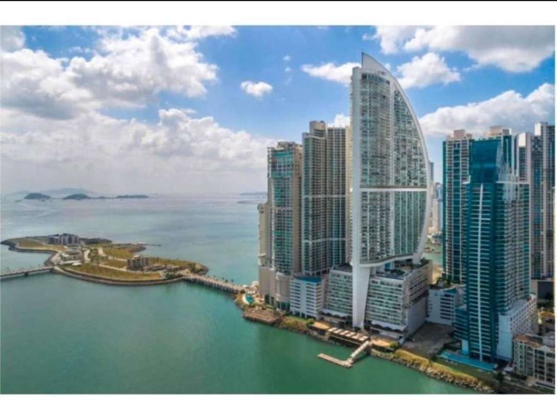 High-floor balcony with glass railing facing panoramic Pacific Ocean and city skyline at JW Marriott Panama