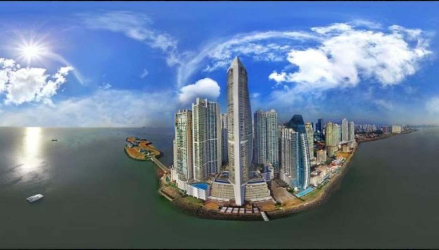 Luxury infinity pool facing Pacific Ocean at JW Marriott Panama with lounge chairs and palm trees