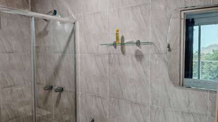 Small bathroom with glass shower, pedestal sink, tiled at La Laguna Eco Cabins Panama