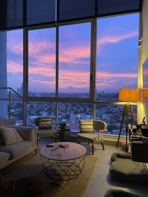 Double-height living room with city skyline views at PH Sky Park Panama City