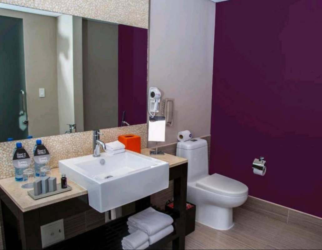 Bedroom with king bed and bay window with ocean skyline view in luxurious Megapolis Tower Panama