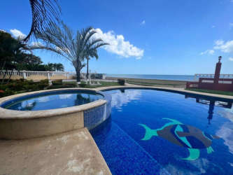 Bathroom with vanity cabinet, wall mirror, shower curtain, and ceramic tile flooring in Playa Gorgona condo