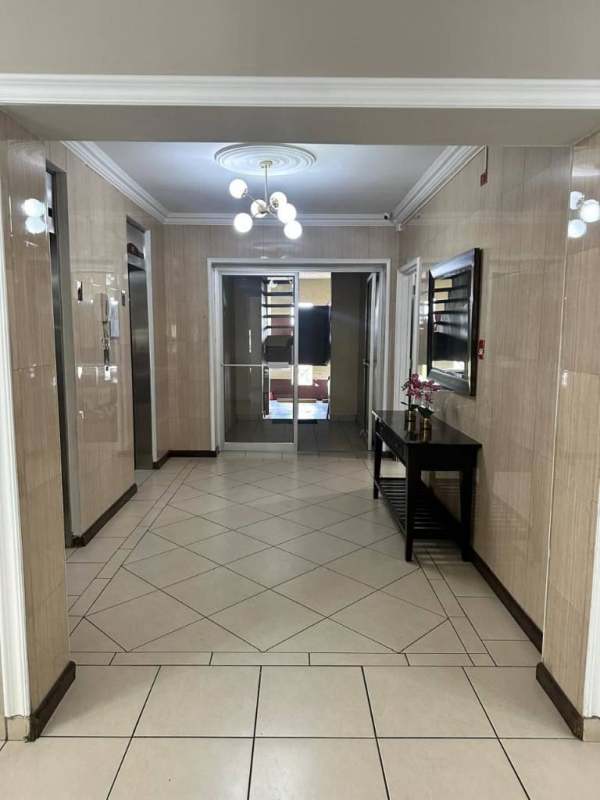 Lobby with elevators glass doors tile flooring PH Nuova Villa Panama City