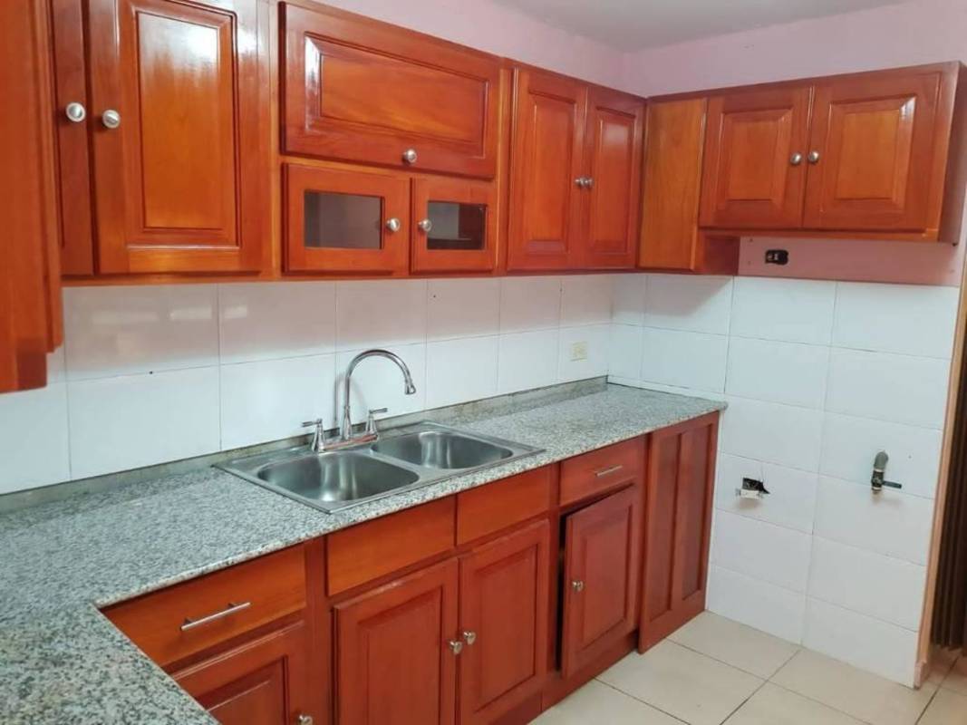 Kitchen with granite countertop wood cabinetry double sink PH Nuova Villa Panama