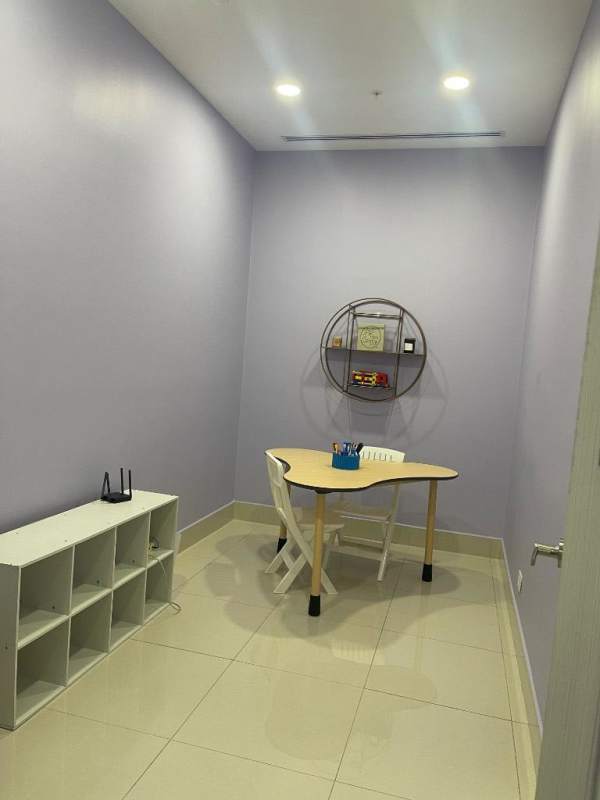 Small study with light purple walls, shelving, minimalist desk in Costa del Este Panama