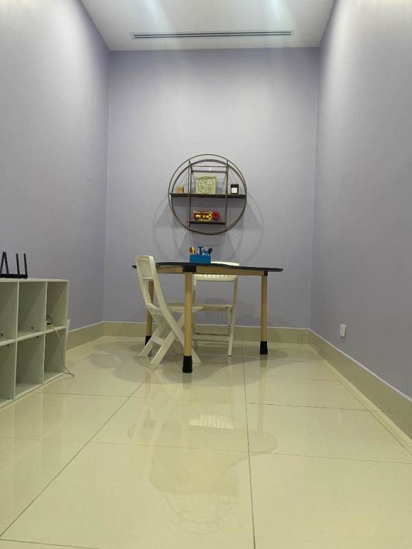 Minimalist office with light purple walls, desk, chair in Costa del Este Panama medical tower