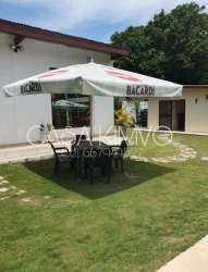 Large covered outdoor terrace with lounge seating and tropical plants at Casa Kimvo Playa Malibu Panama