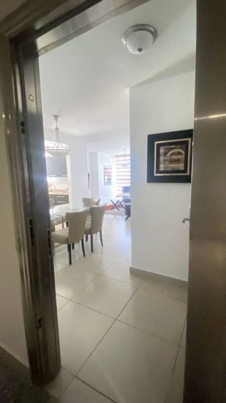 Large swimming pool area with lap pool and lounge chairs PH Kings Park Panama City