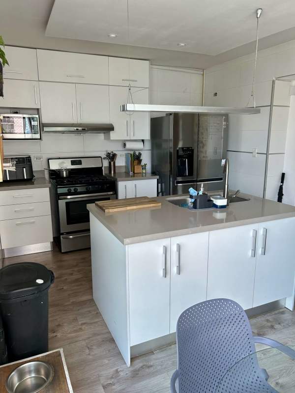 Modern kitchen cabinetry, granite countertops, island at PH San Francisco Bay